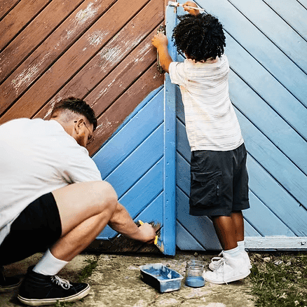 Father son painting fence